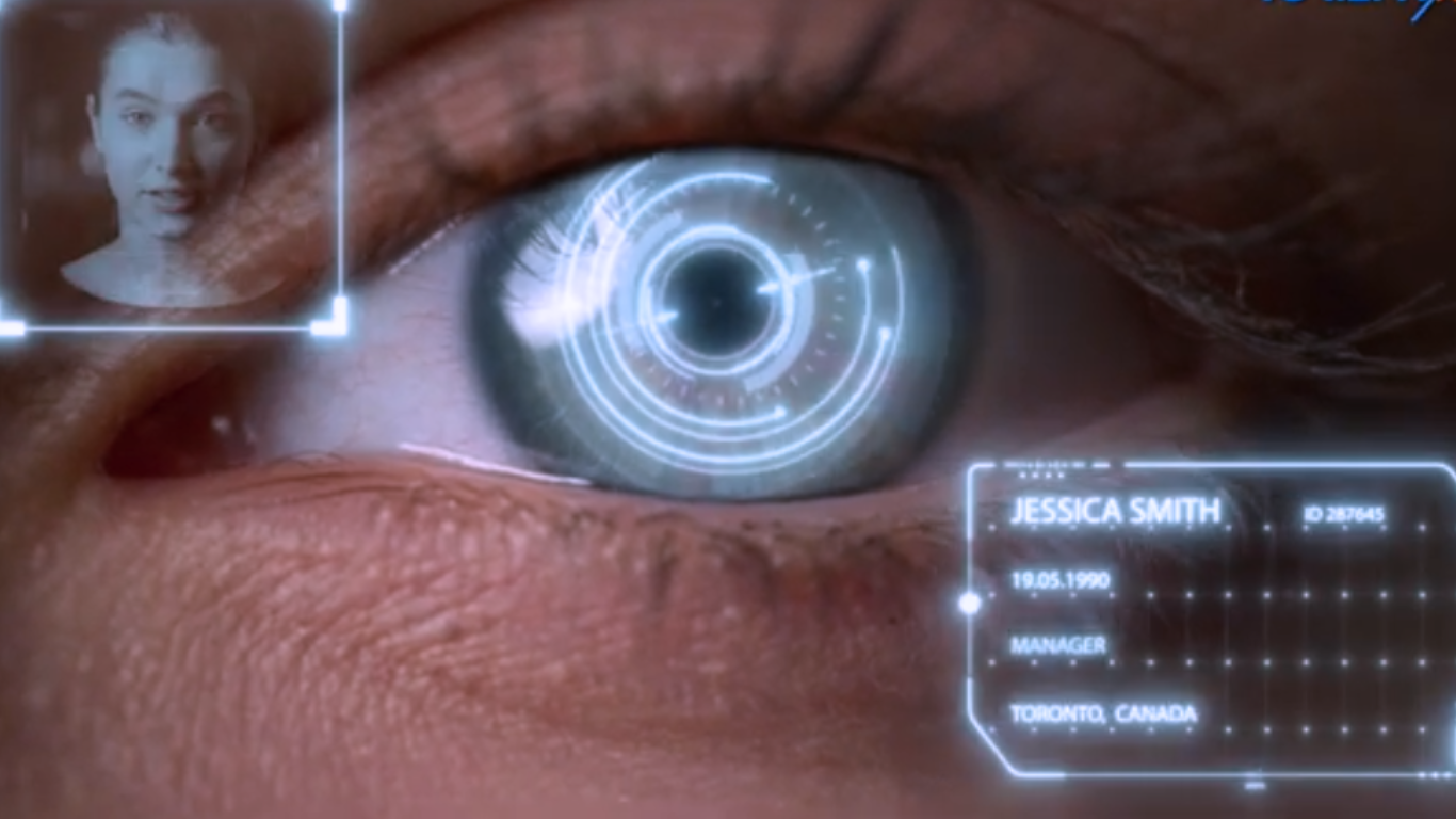 Close-up of a human eye with a digital interface overlay showing biometric facial recognition and personal identification data.