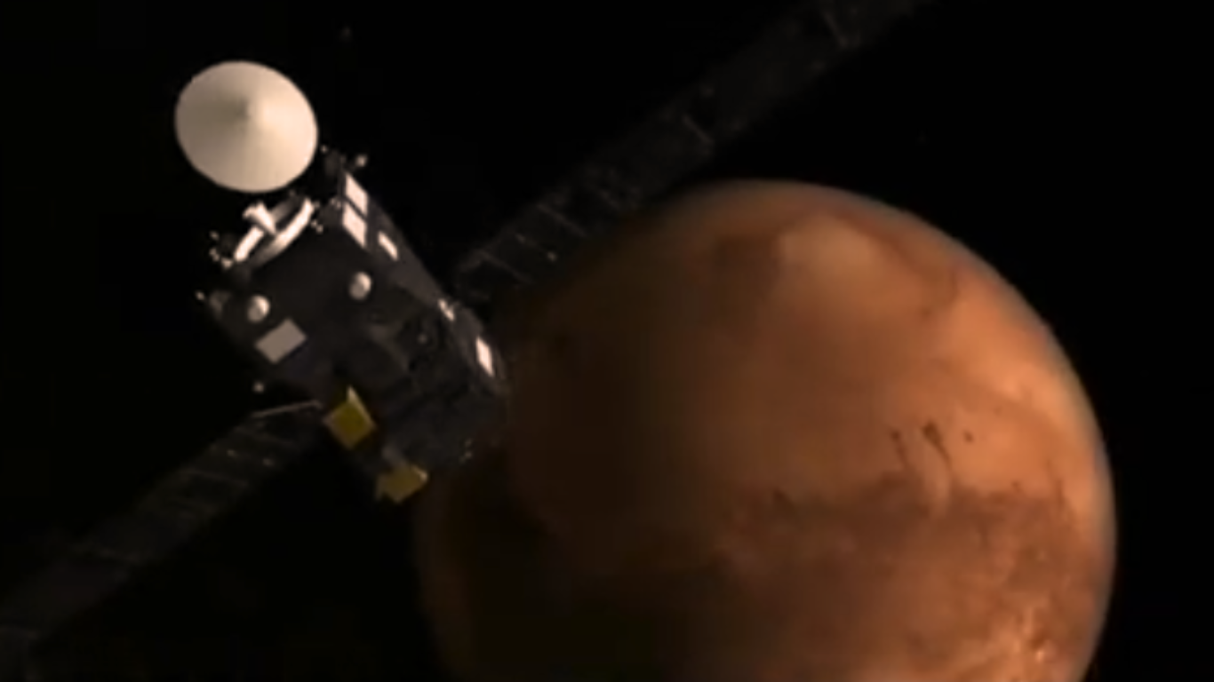Satellite with solar panels orbiting near Mars, showing the red planet’s surface in deep space.