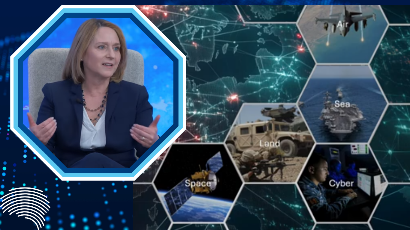 A woman speaking in a studio alongside a digital graphic showing interconnected military domains including air, sea, land, space, and cyber operations.