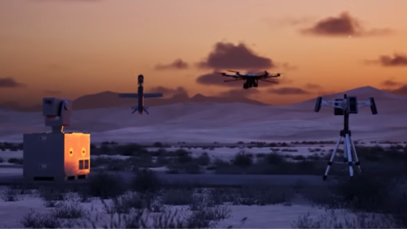 Autonomous drone swarm operating in a desert environment with advanced defense detection systems during sunset https://worldstan.com/swarm-intelligence-in-drone-warfare-vs-defense-system/