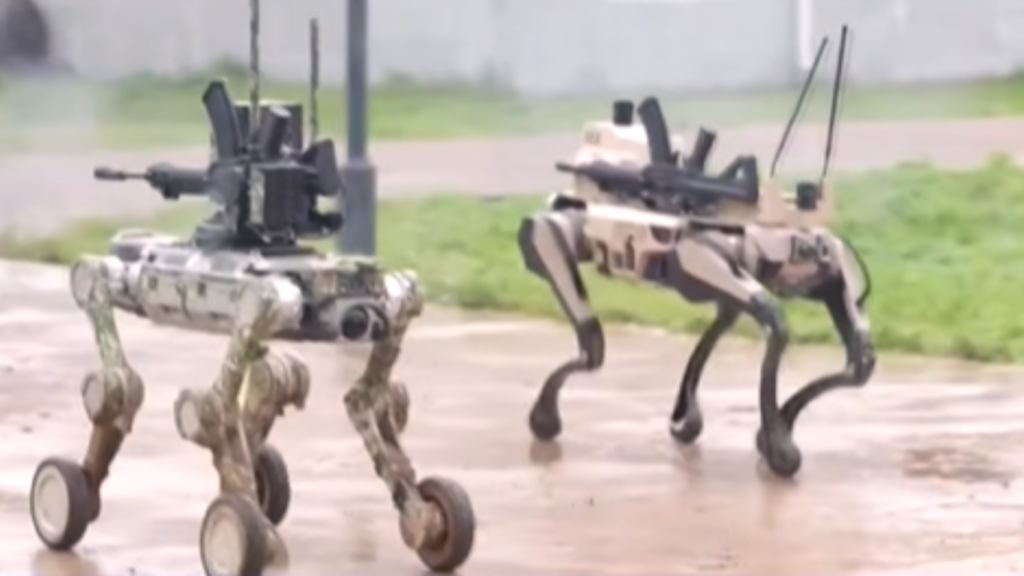 Two quadruped robotic vehicles equipped with mounted weapons walking on a wet surface, designed for autonomous military operations.
