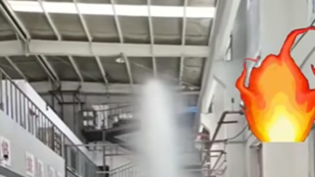 An automated fire suppression system spraying a dense white stream of water inside an industrial facility, illustrating capabilities related to AI Call for Fire Automation.