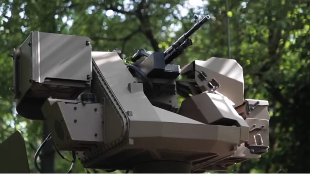 An automated remote weapon station equipped with a machine gun mounted outdoors, demonstrating advanced systems used in AI Defence Operations.