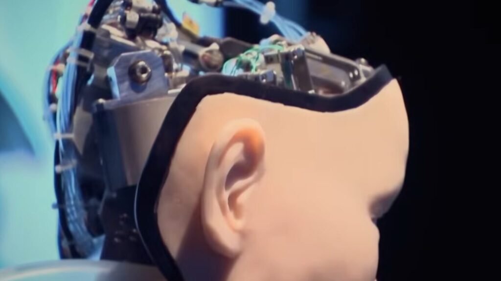 An animatronic humanoid robotic head with synthetic skin and exposed internal wiring gears, demonstrating how AI for Tactical CBRN Defense is changing the way military teams work.