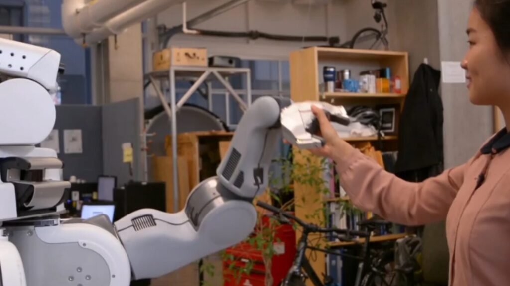 A researcher shaking hands with the multi-jointed robotic arm of a humanoid robot in a laboratory setting, illustrating human-robot interaction concepts discussed alongside the Ethics of Lethal Autonomous Weapons.