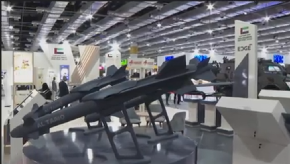 Two dark gray precision-guided munitions labeled Al Tariq displayed on stands at a defense exhibition showcasing technologies used in Centaur Warfare.