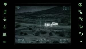 Military AI targeting interface tracking people next to a vehicle at night